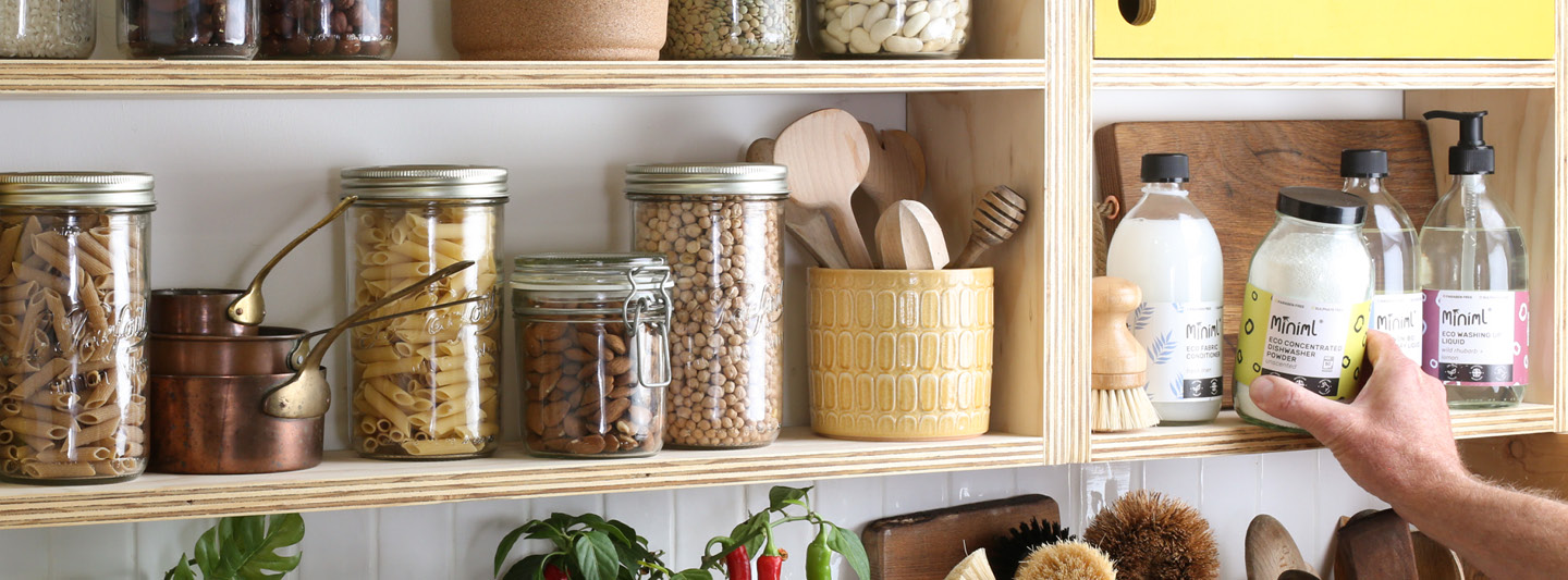 Storage jars on a shelf, full of our Club Zero pantry and household products