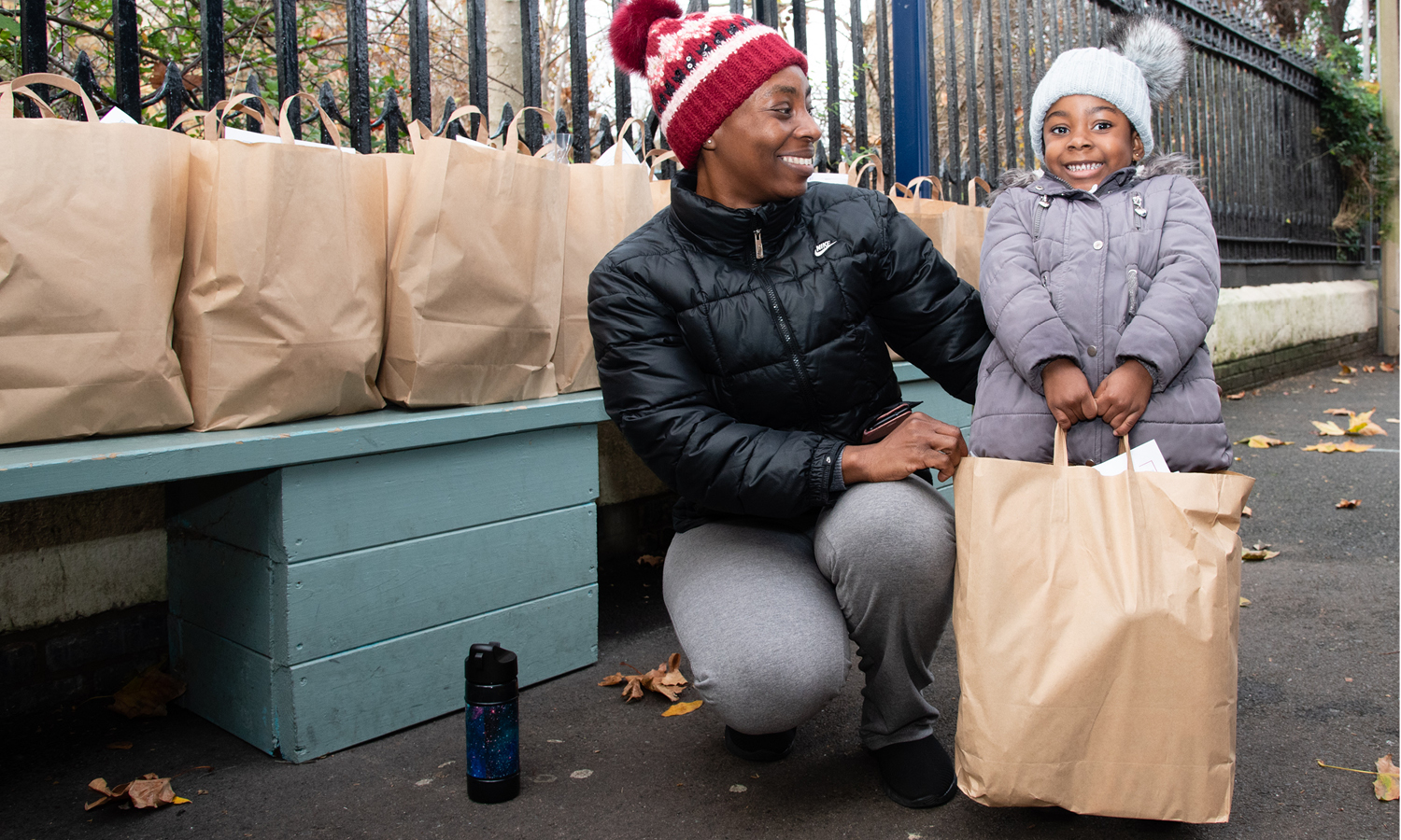 Mum and daughter smiling with food package