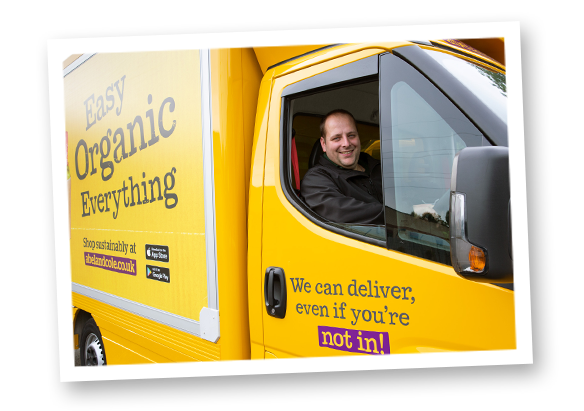 A photograph of an Abel & Cole delivery driver in an Abel & Cole yellow van