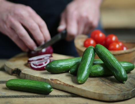 organic mini cucumbers being chopped