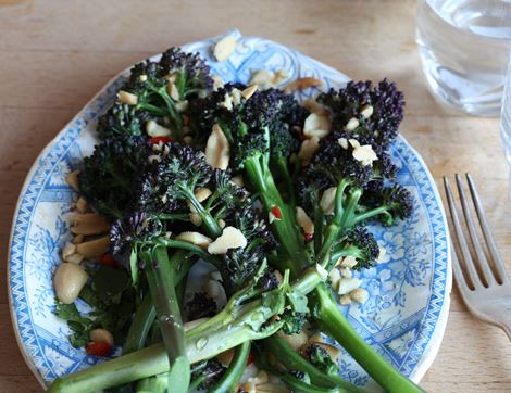 organic purple sprouting broccoli cooked with pine nuts